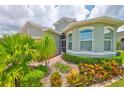 Landscaped front yard showcasing vibrant greenery and a charming path to the entrance at 724 Chipper Dr, Sun City Center, FL 33573