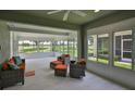 Bright sunroom with tiled floor, large windows, and comfortable seating overlooking the landscape at 724 Chipper Dr, Sun City Center, FL 33573