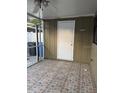 Enclosed patio with tiled flooring and door leading inside at 7605 W Deleon Ct, Tampa, FL 33615