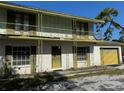 Two-story brick home featuring a wrought iron balcony, shutters, and a yellow garage door at 8244 125Th St, Seminole, FL 33772
