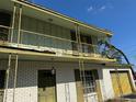 Close up on a two-story home with a wrought iron balcony and shutters at 8244 125Th St, Seminole, FL 33772