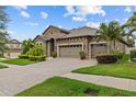 Lovely single-story home with well-maintained landscaping, brick paved driveway, and three-car garage at 1002 Cavour Ct, Brandon, FL 33511