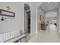 Inviting foyer with neutral paint, tile flooring, and an arched doorway leading to other living spaces at 1002 Cavour Ct, Brandon, FL 33511