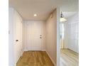 Welcoming foyer with wood-look tile, closet, and access to living areas at 1041 Bowsprit Ln # 1041, Holiday, FL 34691