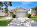Well-maintained single-Gathering home with a two-car garage and manicured front lawn at 10739 Shady Preserve Dr, Riverview, FL 33579