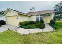 Charming one-story home with a well-maintained lawn, two-car garage, and inviting landscaping at 10806 Brookhaven Dr, New Port Richey, FL 34654