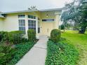Inviting front entrance with a well-manicured lawn and lush landscaping at 10806 Brookhaven Dr, New Port Richey, FL 34654