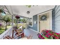 Charming front porch featuring comfortable seating and decorative floral accents at 112 W Mohawk Ave, Tampa, FL 33604