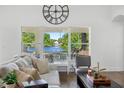 Serene living room with natural light and a beautiful lake view, complete with stylish furnishings and decor at 13409 Fawn Springs Dr, Tampa, FL 33626