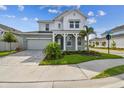Charming two-story home with manicured lawn, lovely landscaping and a welcoming front porch at 1586 Running Tide Pl, Sarasota, FL 34240