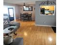Cozy living room featuring hardwood floors, dining area and pass-through window to the kitchen at 1663 Cambridge Dr, Clearwater, FL 33756
