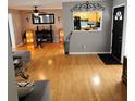 Cozy living room featuring hardwood floors and an open view into the kitchen at 1663 Cambridge Dr, Clearwater, FL 33756