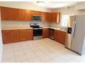 Modern kitchen with stainless steel appliances and wooden cabinets at 17236 Spring Valley Rd, Dade City, FL 33523