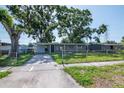 Exterior shot of a single-story home with covered parking and mature trees at 2004 Windsor Way, Tampa, FL 33619
