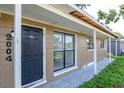 Close-up of the home's entrance with covered porch and traditional front door at 2004 Windsor Way, Tampa, FL 33619