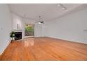 Open living room showcasing the fireplace, wood floors, and natural light at 3044 Red Oak Ct # 204, Palm Harbor, FL 34684