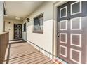 Condo unit entrance featuring a brown door with white trim and adjacent window at 3055 Casa Del Sol Cir # 202, Clearwater, FL 33761