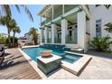 Inviting pool and spa area with elegant tile accents and outdoor seating at 3125 Christophers Watch Ln, Ruskin, FL 33570