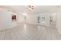 Bright and spacious living room features tile flooring and glass patio doors at 31645 Bugle Ln, Wesley Chapel, FL 33543