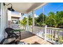 Cozy porch features comfortable seating, offering a relaxing outdoor space with views of a tropical street at 340 6Th E St, Bradenton, FL 34208