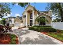 Attractive two-story home featuring a large double door entry, three car garage, and manicured landscaping at 4515 W Leona St, Tampa, FL 33629