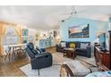 Cozy living room open to the dining area with comfortable seating, artwork, and a ceiling fan at 526 5Th N Ave, Safety Harbor, FL 34695