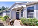 Inviting entryway with a decorative wreath on the front door and a cozy bench at 6030 Sandhill Ridge Dr, Lithia, FL 33547