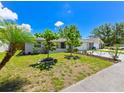 A cozy home with mature trees and manicured landscaping that enhances the curb appeal at 6705 Ranger Dr, Tampa, FL 33615