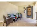 Cozy outdoor porch area featuring comfortable wicker furniture, perfect for relaxation and enjoying the fresh air at 7520 Sunshine Skyway S Ln # 113, St Petersburg, FL 33711