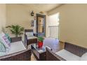 Inviting porch with comfortable wicker seating, a glass table, and a charming view at 7520 Sunshine Skyway S Ln # 113, St Petersburg, FL 33711