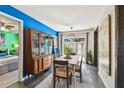Bright dining room with modern table and chairs, adjacent to a bedroom and with backyard access at 905 8Th Sw Ave, Largo, FL 33770