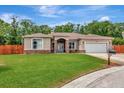 Attractive one-story house with a green lawn and attached garage offers comfort and curb appeal at 10305 Worthy Lamb Way, New Port Richey, FL 34654