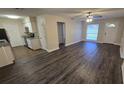Bright, open-concept living area seamlessly connects to the kitchen, featuring modern floors and ample natural light at 11259 Elgin Blvd, Spring Hill, FL 34608