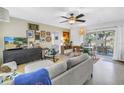 Stylish living room with neutral furniture, eclectic decor, and a seamless flow to the outdoor patio at 11376 119Th Ter, Largo, FL 33778
