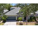 Charming single-Gathering home featuring a well-manicured lawn and a two-car garage with beautiful landscaping at 12443 Adventure Dr, Riverview, FL 33579
