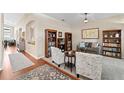 Spacious living room featuring hardwood and carpet flooring, comfortable seating, and built-in bookshelves at 12443 Adventure Dr, Riverview, FL 33579
