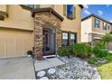 Inviting front entrance featuring stone accents, a colorful screen door, and well-maintained landscaping at 12643 Horseshoe Bend Dr, Lithia, FL 33547