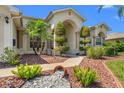 Close-up of home showcasing its arched entryway, meticulously trimmed shrubs, and decorative rock landscaping at 13375 Newcastle Ave, Spring Hill, FL 34609