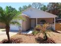 Inviting single-story home with a cozy front porch and well-manicured landscaping at 1344 S Michigan Ave, Clearwater, FL 33756