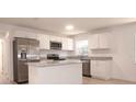 Modern kitchen features white cabinets, granite countertops, and stainless steel appliances at 1344 S Michigan Ave, Clearwater, FL 33756