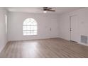 Bright and airy living room featuring neutral paint, updated flooring, a ceiling fan, and natural light at 1344 S Michigan Ave, Clearwater, FL 33756