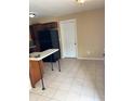 Eat-in kitchen featuring dark cabinetry, black refrigerator and neutral walls at 1427 15Th S St, St Petersburg, FL 33705