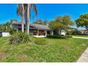 Well-manicured front lawn featuring colorful foliage and verdant landscaping at 1622 El Tair Trl, Clearwater, FL 33765