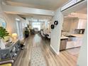 Inviting living room featuring an open floor plan with a dining area and a modern kitchen at 18108 Ashton Park Way, Tampa, FL 33647
