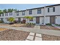 Shot of townhouse exteriors with tropical plants and white painted brick facade at 2011 S Carolina Ave, Tampa, FL 33629