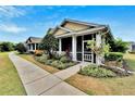 Inviting home with a screened porch, mature landscaping, and a welcoming walkway under a blue sky at 215 Sela Cove Cir, Apollo Beach, FL 33572