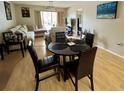 Open floor plan with dining table and chairs near a living room with plush couches at 220 Cypress Ln # 220, Oldsmar, FL 34677