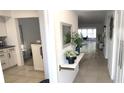 Inviting hallway with neutral tones and stylish decor leading to the bright living area at 2261 Swedish Dr # 59, Clearwater, FL 33763