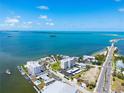Wide aerial view of waterfront condos, a marina, and beautiful blue water at 2530 Gary Cir # 301, Dunedin, FL 34698