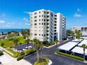Exterior shot of the Marina Tower condos with a well maintained lawn and parking area at 2530 Gary Cir # 301, Dunedin, FL 34698